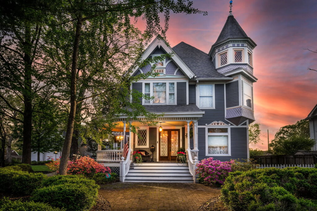 exterior of Victorian home with sunset