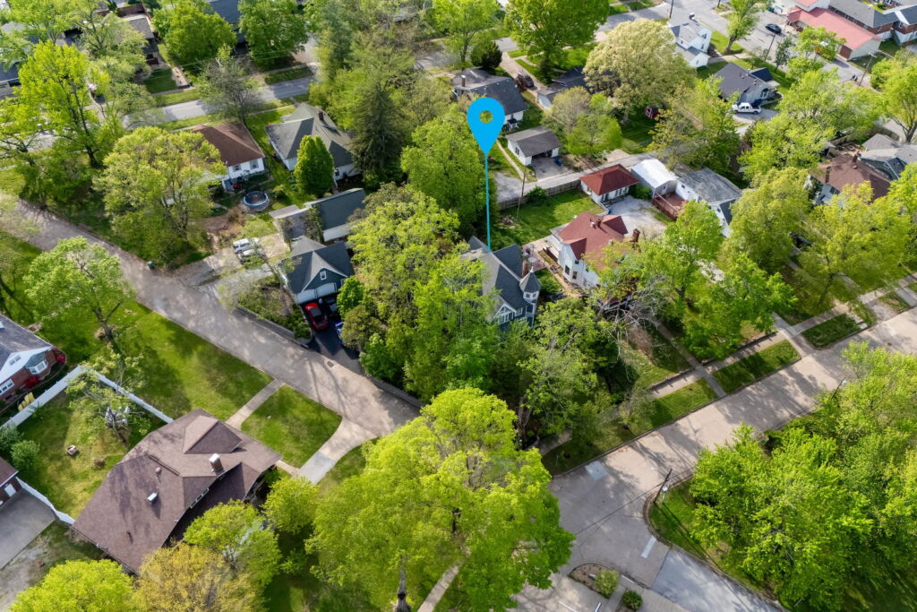 drone photo that shows location of Nook and Key 1983 in Anna, IL. Home is surrounded by trees and nearby homes.