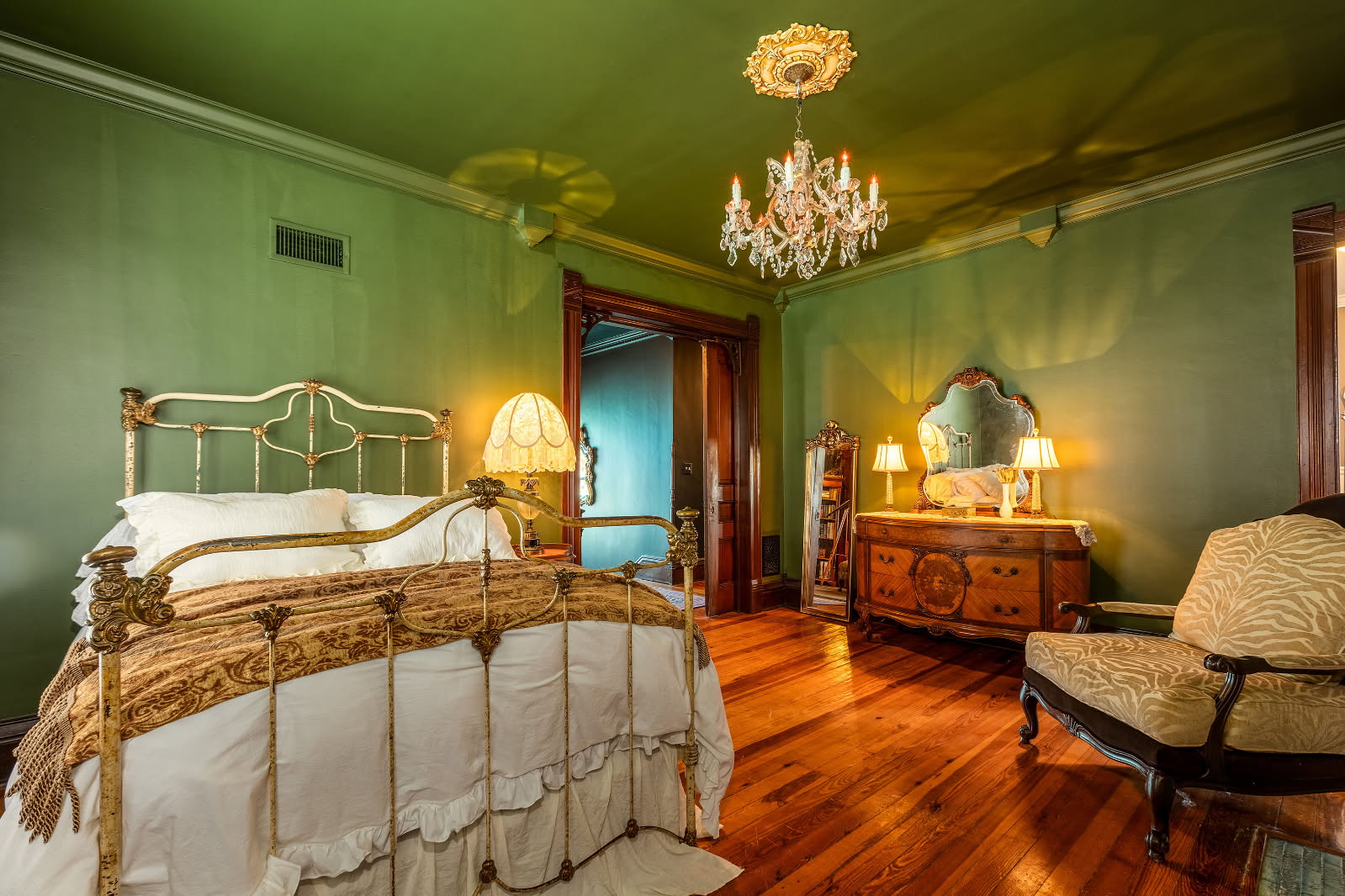 bedroom with green walls and antique furniture