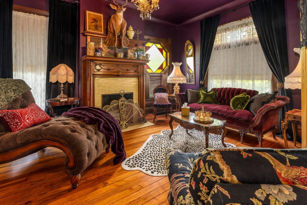 Nook and Key 1983 in Anna, IL offers cozy living room with fireplace, sofa and chairs. Antique furniture and styling perfect for event photograpahy.